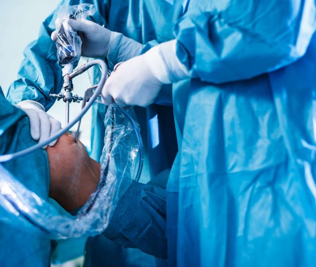 Knee surgery, Orthopedic Operation  - two surgeons performing a knee surgery on a patient (shallow DOF; color toned image)